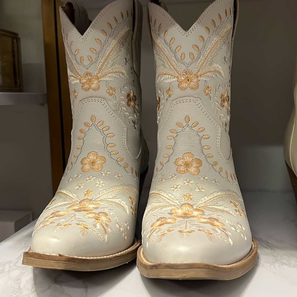 White cowgirl boots with handmade gold flower stitching